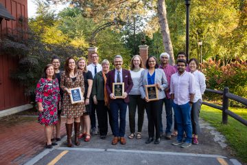 Postdoc Award winners and members of the community outside the Big Red Barn at the award ceremony